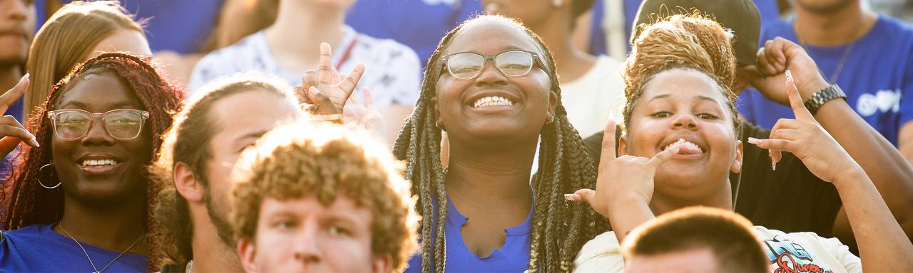 Students smiling in the stands at Lubbers Stadium